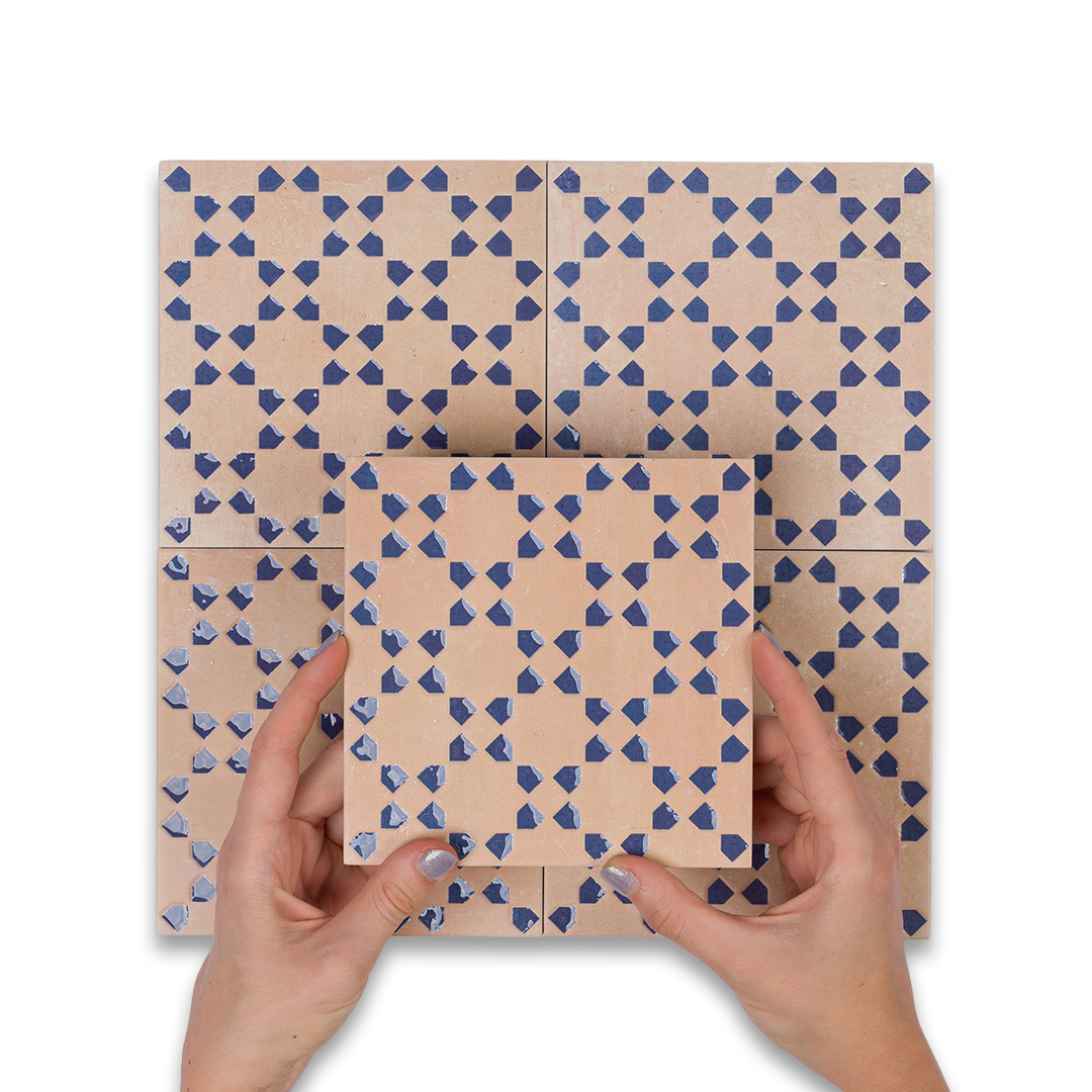 Hands holding a geometric patterned cardboard box on a white background
