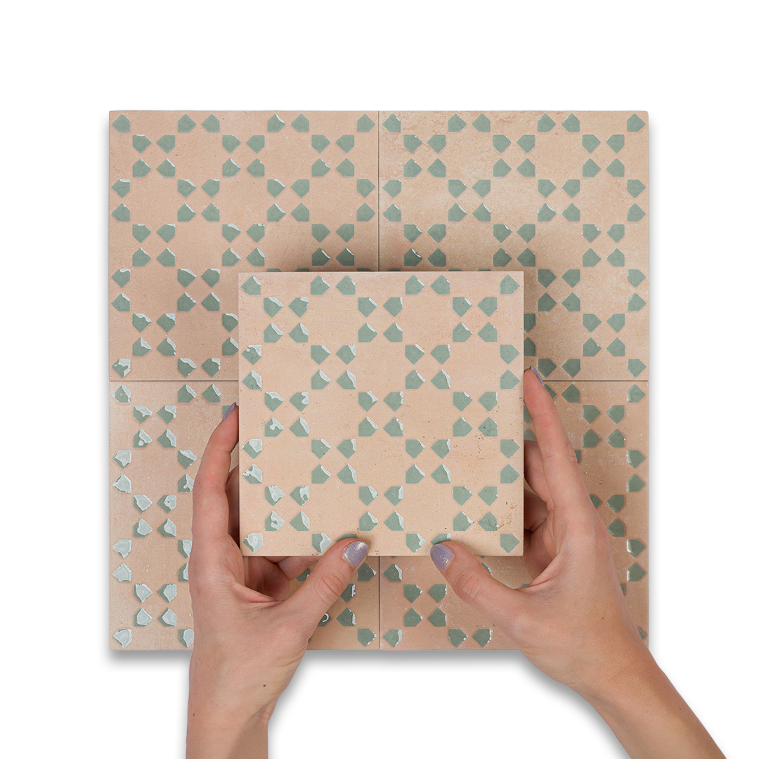 Hands holding a square box with a geometric pattern on a matching background
