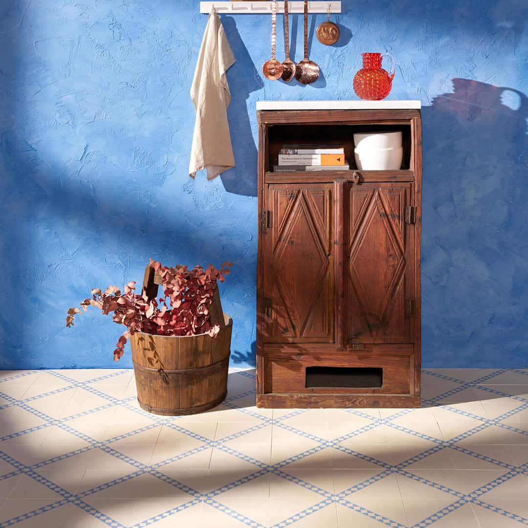 Azure Lattice cement tile featuring a cream base with a diagonal blue diamond pattern, ideal for vintage-inspired interiors, decorative flooring, and wall applications in modern Mediterranean spaces.