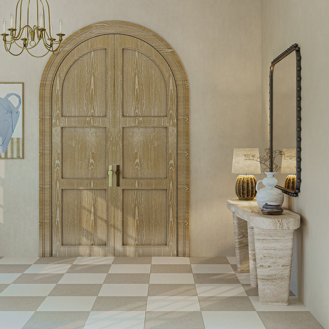 Wooden door in a room with a checkered floor, lamp, and mirror.
