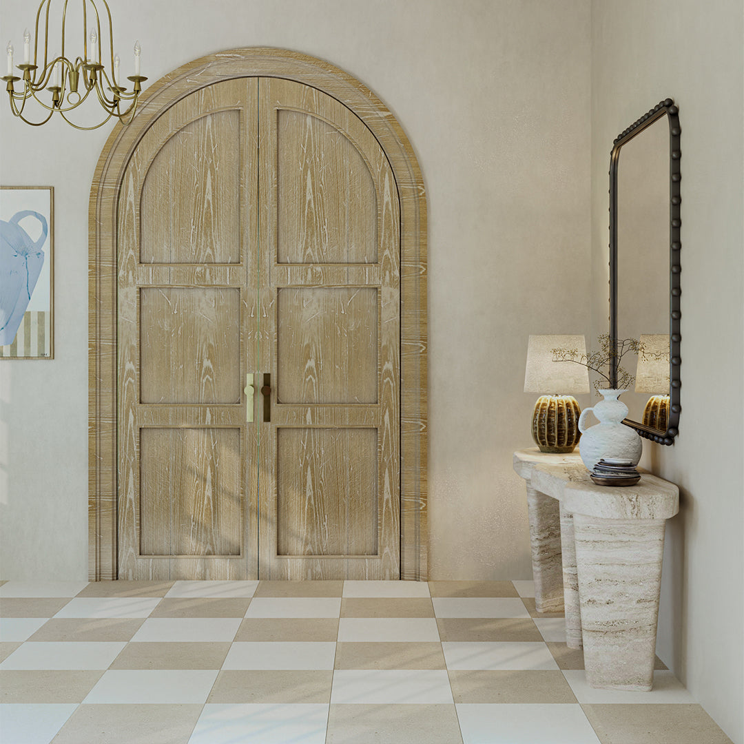 Wooden door in a room with a checkered floor, lamp, and mirror.