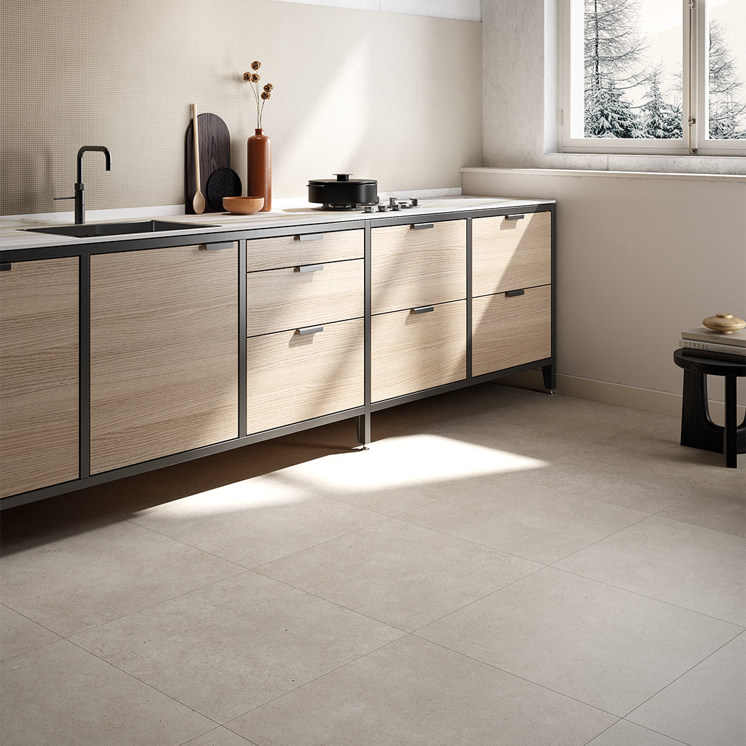 Modern kitchen with wooden cabinets and a window view of snow-covered trees.