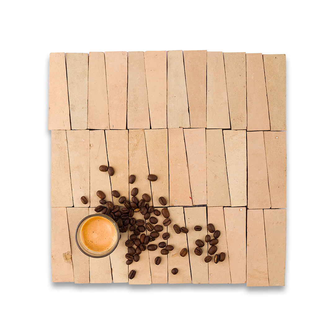 Wooden coaster with coffee beans and a small cup of coffee on a white background