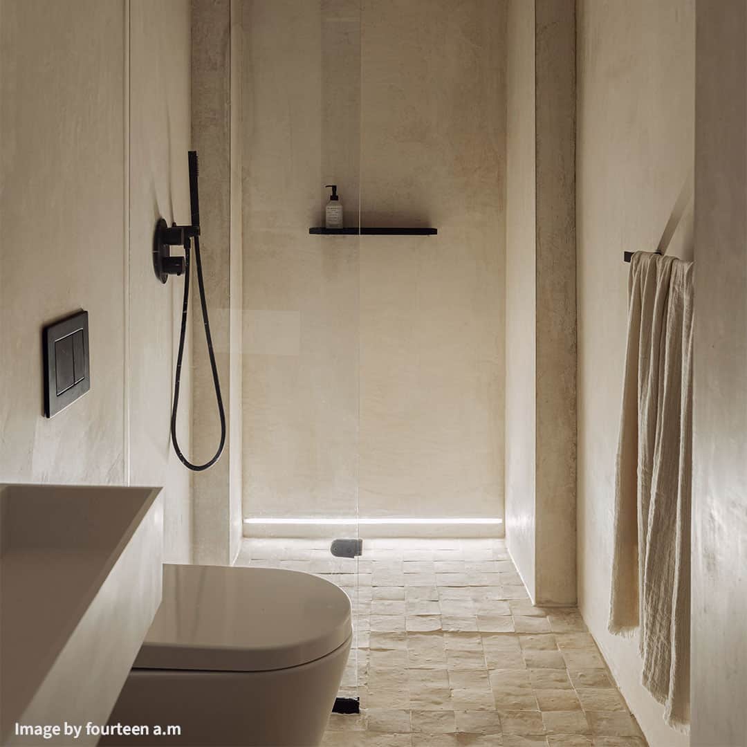 A minimalist bathroom with a neutral beige palette.
