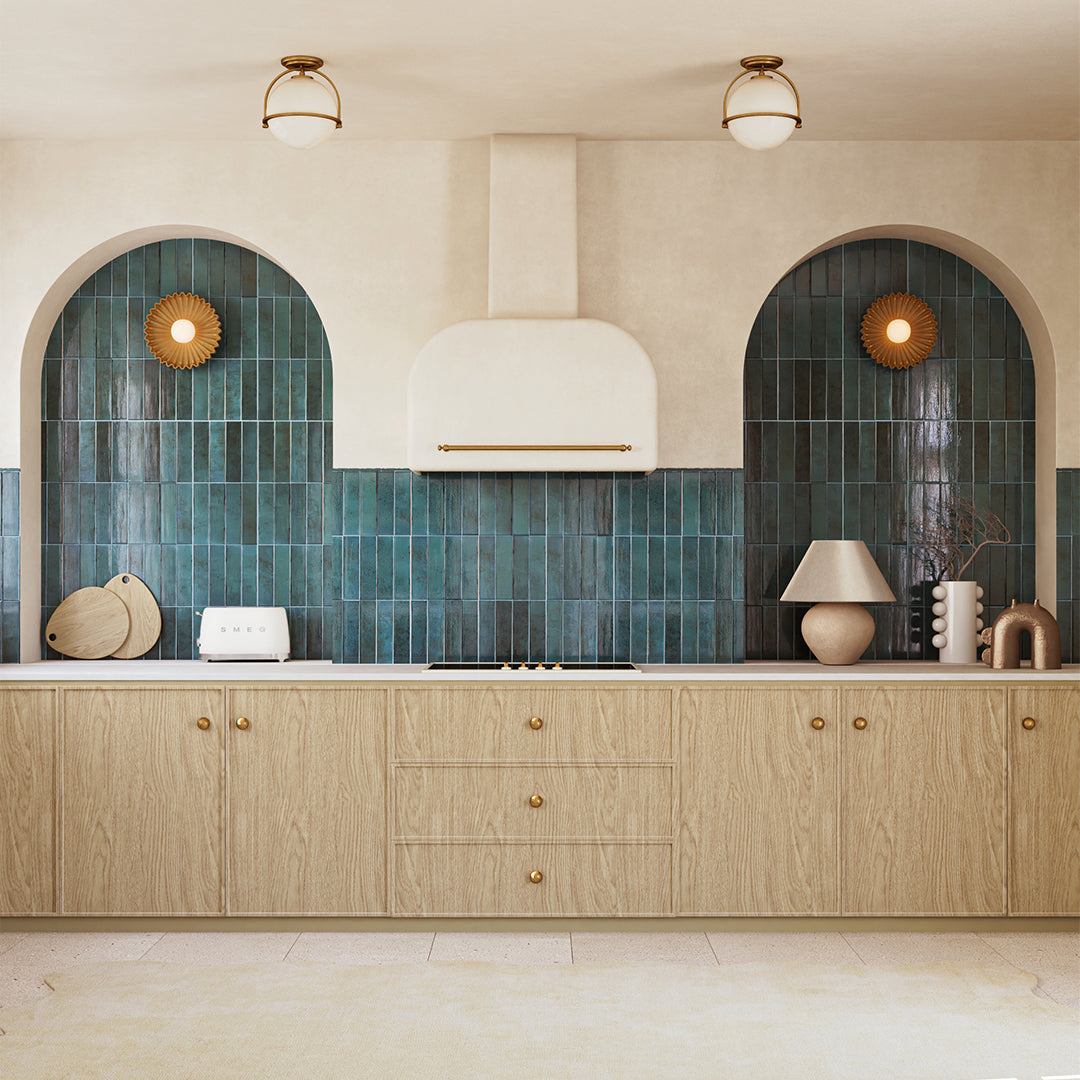Modern kitchen with wooden cabinets, blue tiled backsplash, and decorative lights.