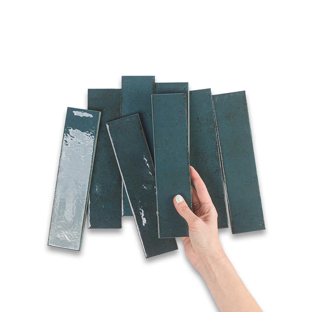 Hand holding a set of teal rectangular tiles on a white background