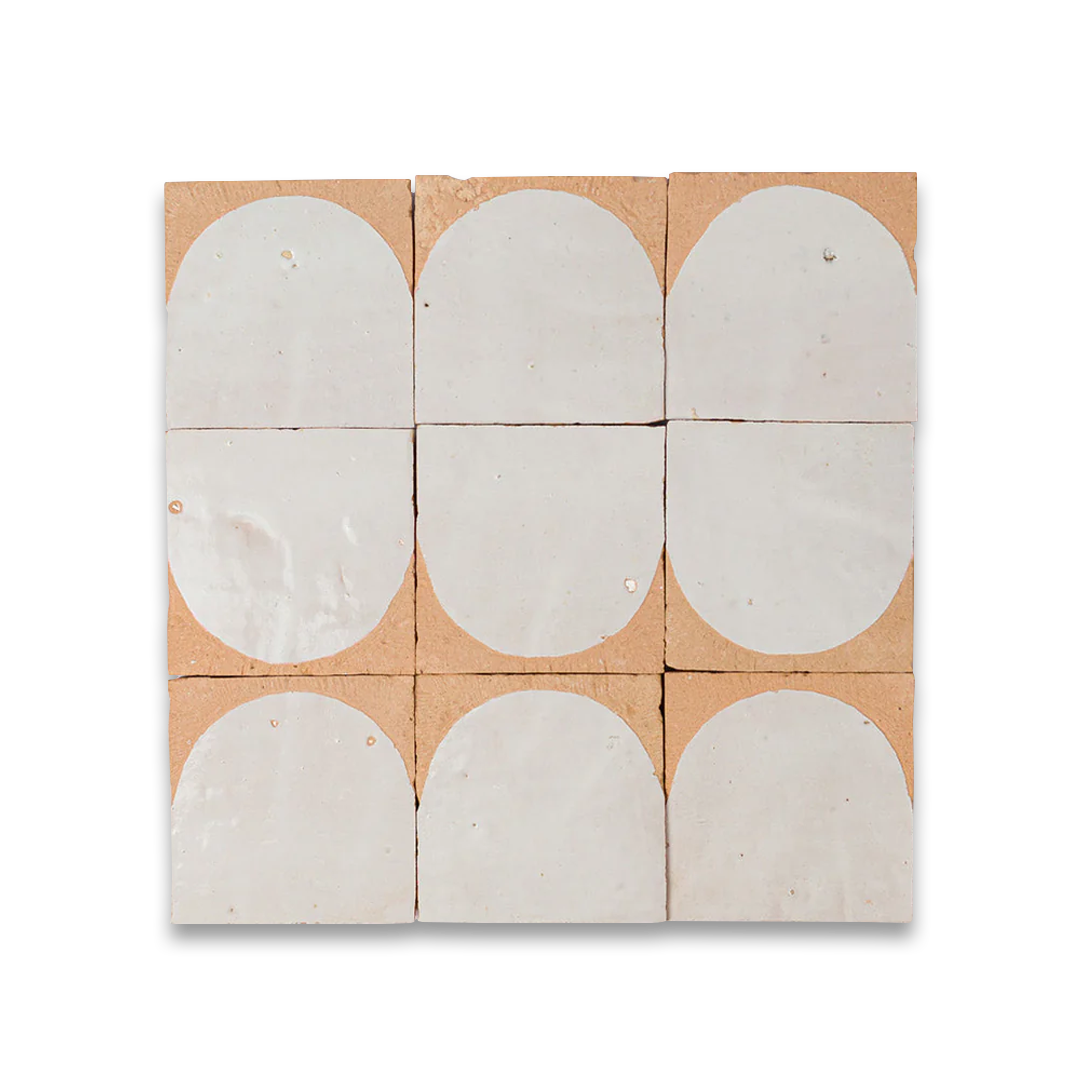 Nine ceramic tiles with circular patterns on a cardboard backing