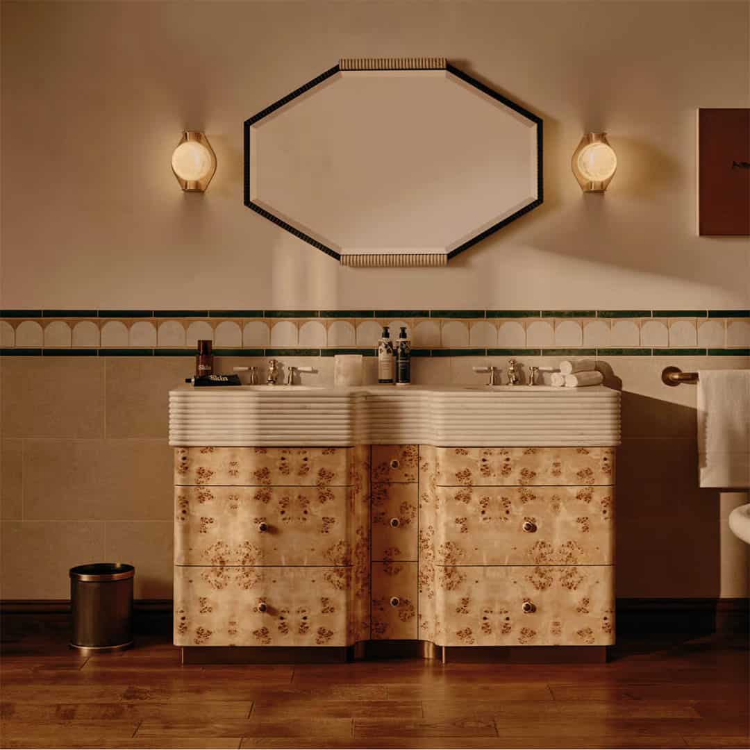 A bathroom vanity with a cream-colored countertop and floral-patterned drawers.