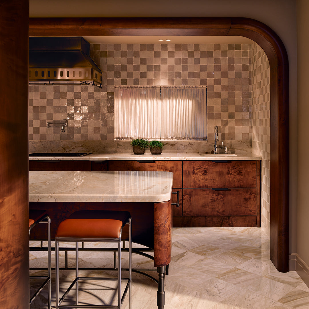 Modern kitchen with wooden cabinets, marble countertop, and checkered backsplash.