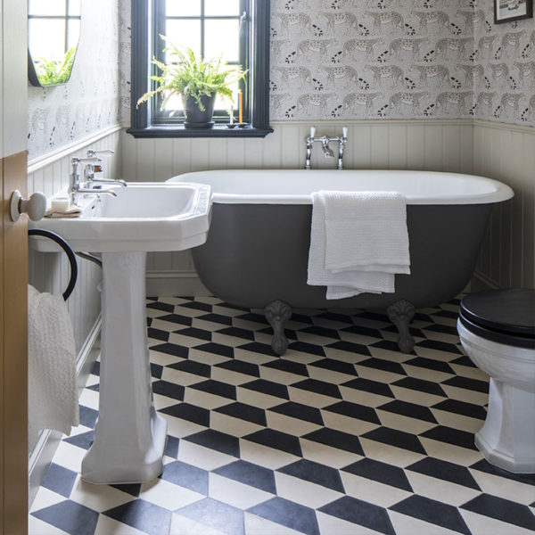 Hex monochrome patterned tiles on bathroom floor bathtub